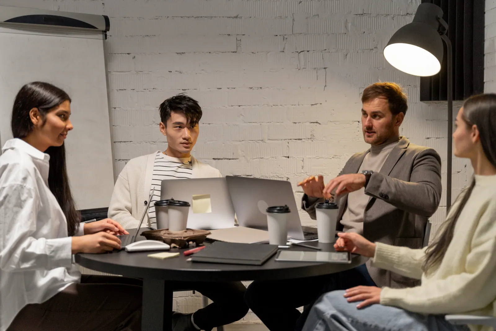 IT Consulting Concept Image - professionals discussing strategy around a table