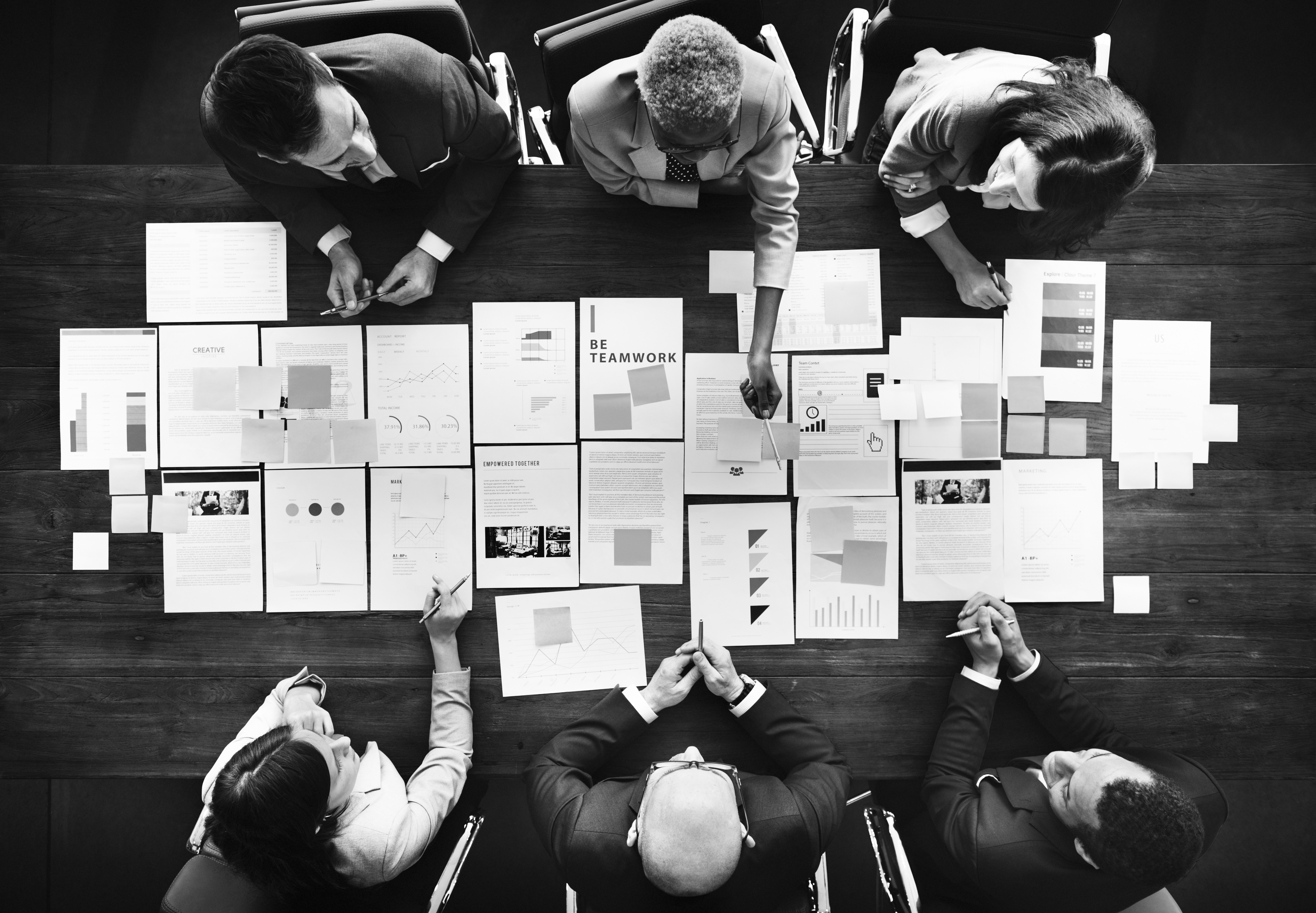 Project Management Concept Image - team planning around a board